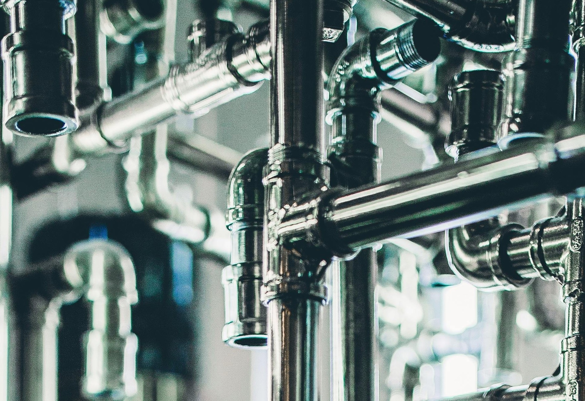 Close-up of a plumbing system with interconnected metal pipes and fittings.