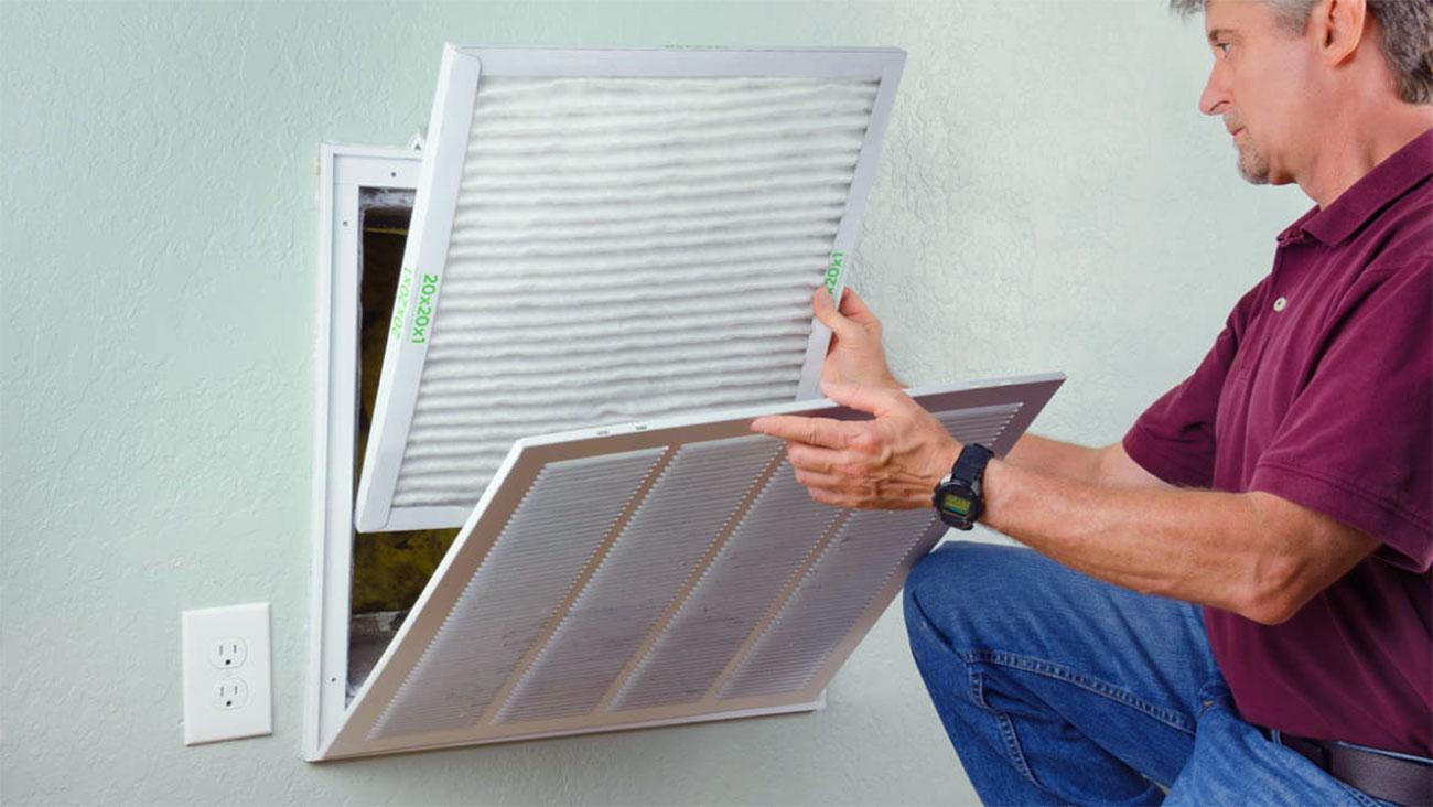 man replacing air filters